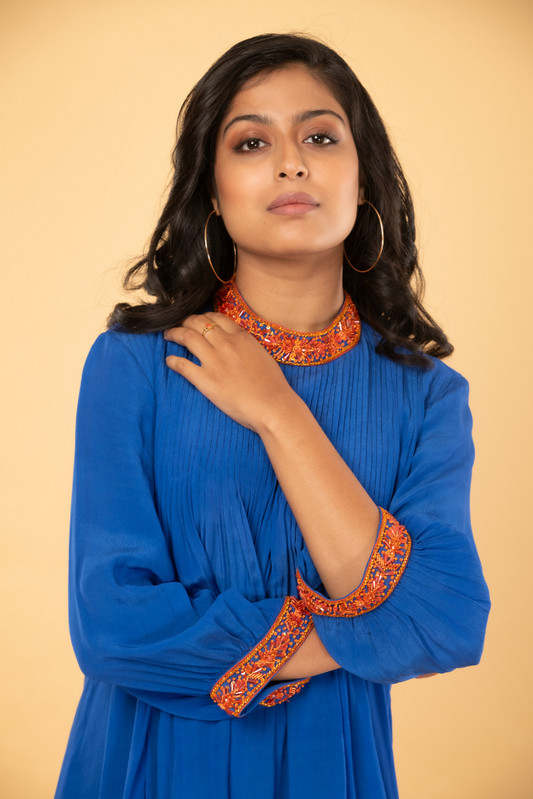 Blue pleated tunic with orange handwork