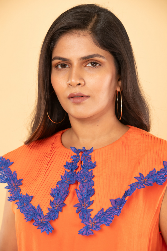 Orange tunic with pleated embroidered collar