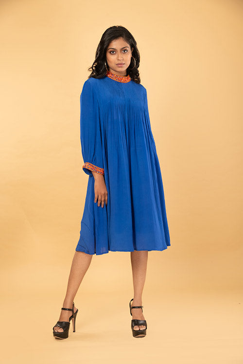 Blue pleated tunic with orange handwork